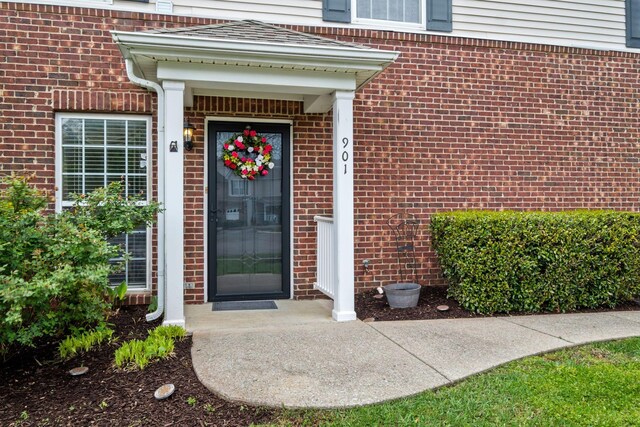 property entrance with brick siding