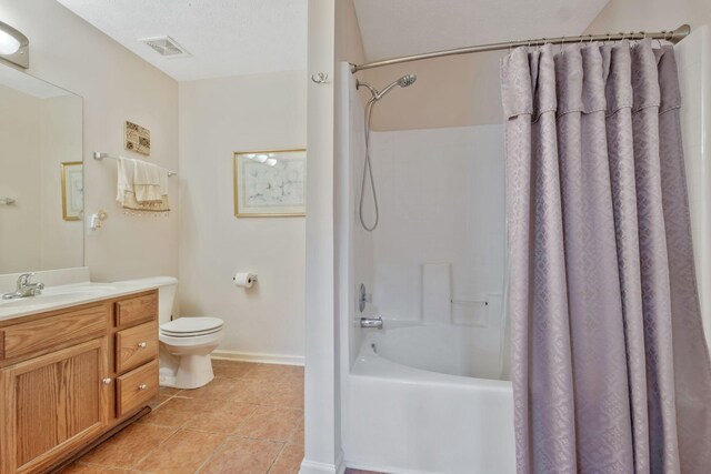 full bathroom with vanity, toilet, tile patterned floors, shower / bath combo with shower curtain, and visible vents