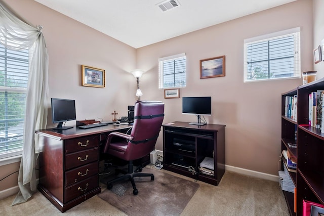carpeted office with visible vents and baseboards