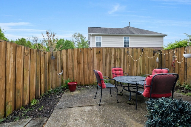 view of patio featuring fence and outdoor dining space