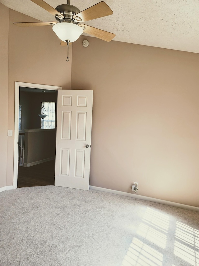empty room featuring baseboards, ceiling fan, and carpet flooring