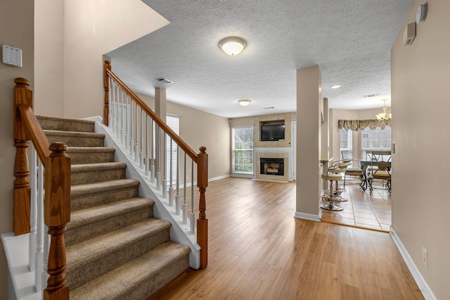 747 Tulip Grove Rd Unit 901, Hermitage, TN 37076 - staircase with plenty of natural light, baseboards, wood finished floors, and a textured ceiling