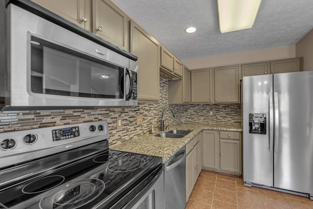 747 Tulip Grove Rd Unit 901, Hermitage, TN 37076 - kitchen with stainless steel appliances, a sink, a textured ceiling, decorative backsplash, and light stone counters