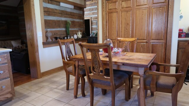 dining space with baseboards and light tile patterned floors