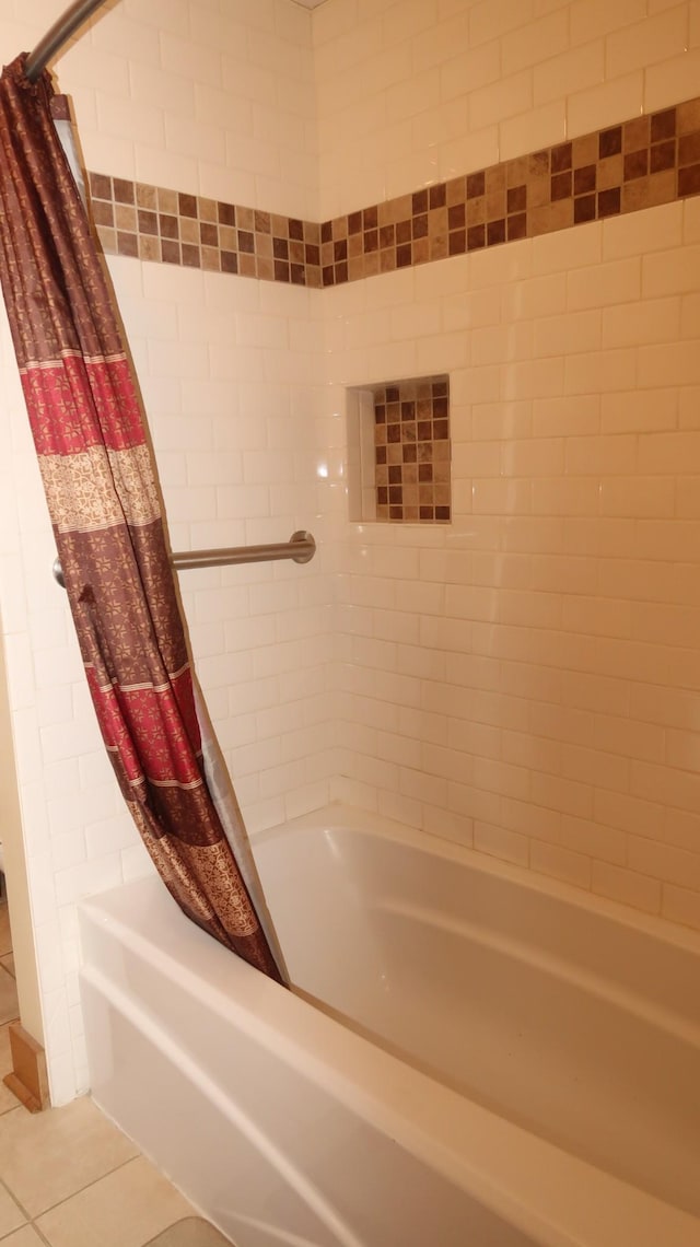 bathroom featuring shower / bath combination with curtain and tile patterned flooring