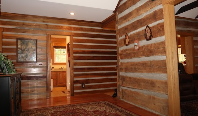 staircase featuring wood finished floors, wood walls, and recessed lighting