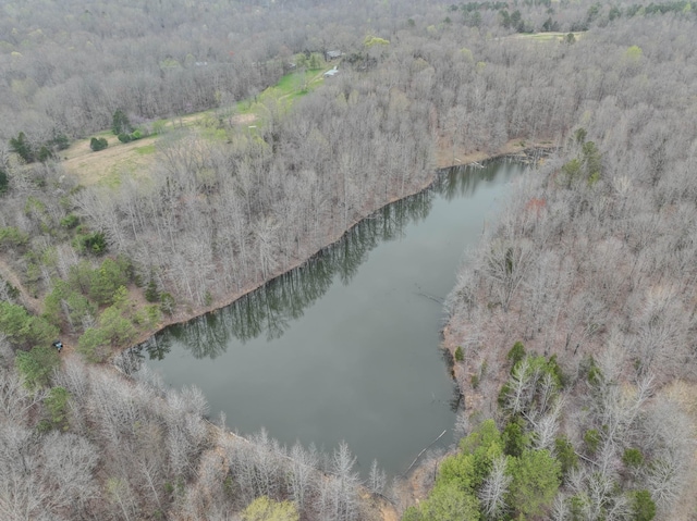 aerial view featuring a wooded view and a water view
