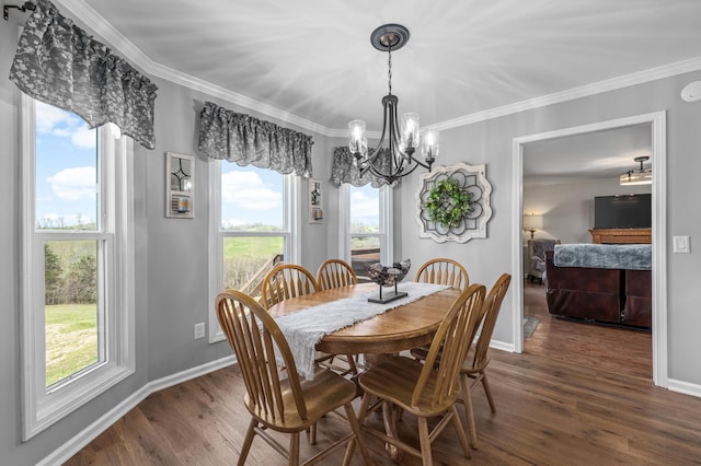 dining area featuring baseboards, wood finished floors, an inviting chandelier, and crown molding