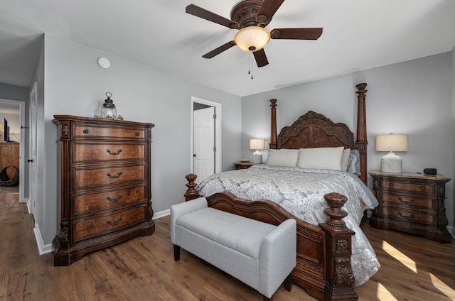 bedroom with baseboards, ceiling fan, and wood finished floors