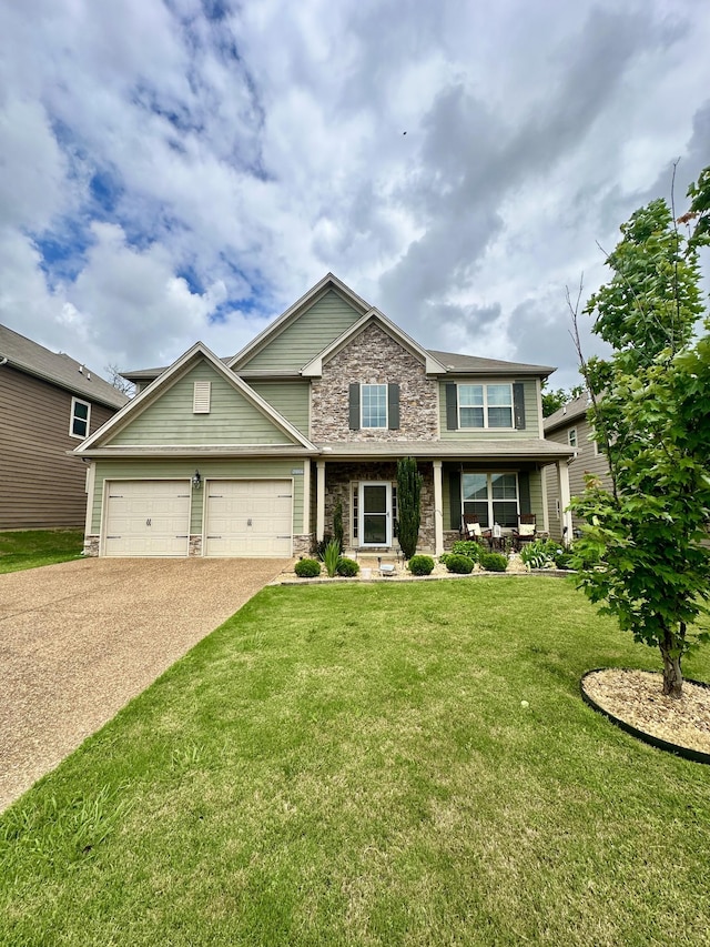 2006 Austin Dr, Spring Hill, TN 37174 - view of front of property featuring stone siding, a front lawn, driveway, an attached garage, and a porch