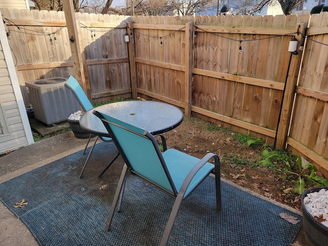 view of patio / terrace with cooling unit and fence