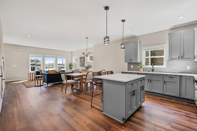 kitchen with gray cabinetry, light countertops, and dark wood finished floors