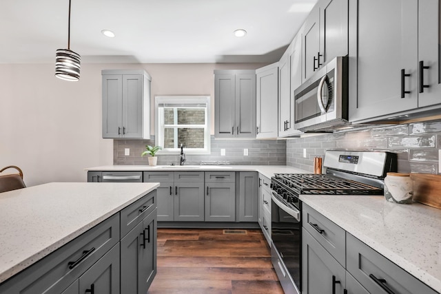 kitchen featuring gray cabinets, a sink, and appliances with stainless steel finishes