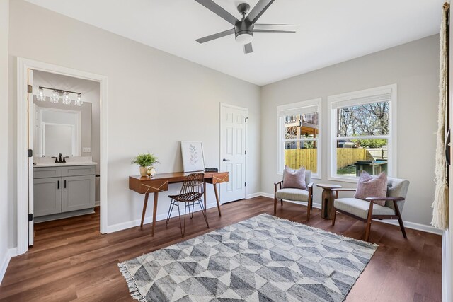 sitting room featuring baseboards, wood finished floors, and a ceiling fan
