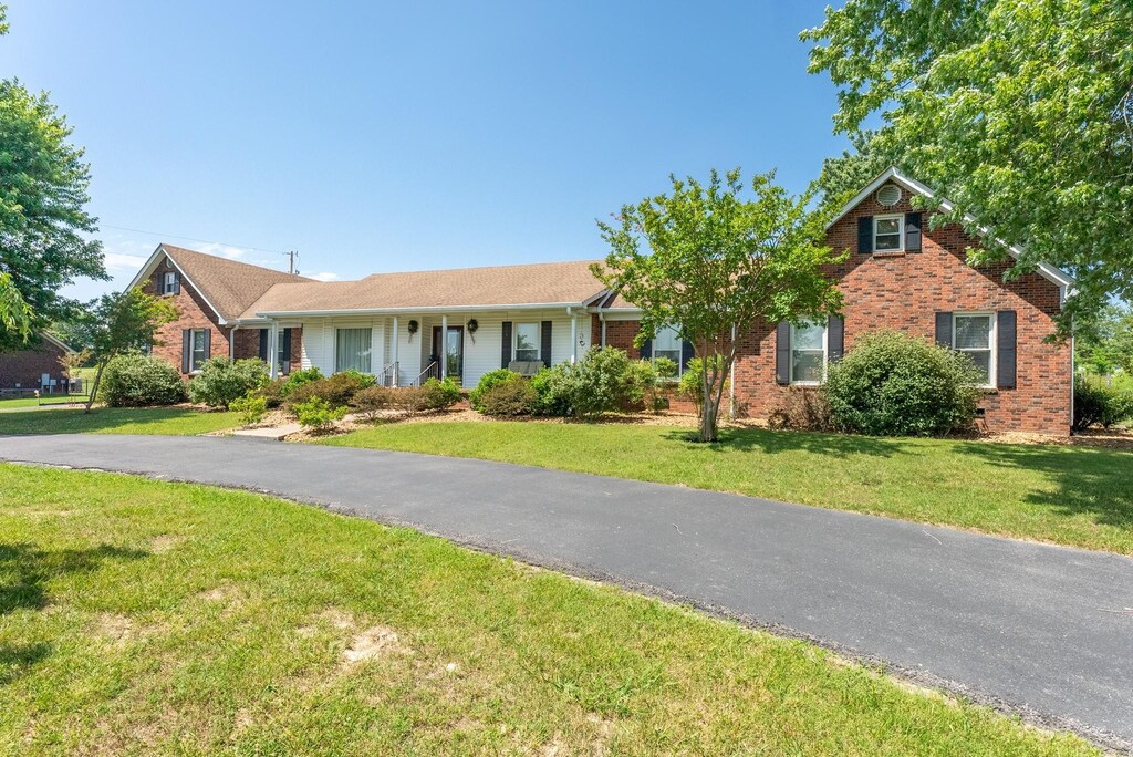 view of front of house with brick siding and a front yard