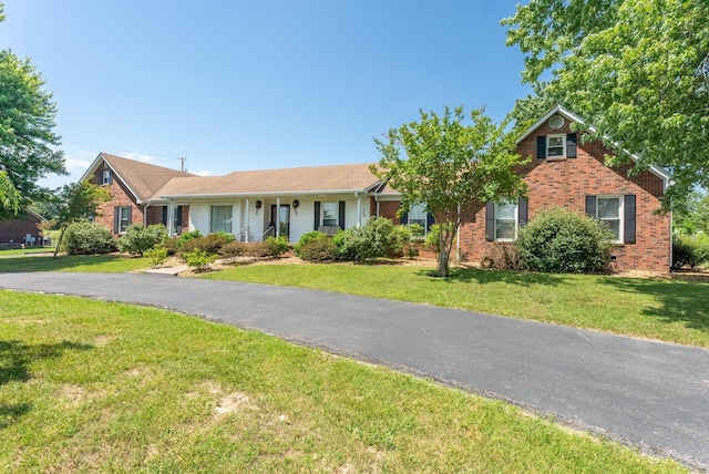 view of front of house with brick siding and a front yard