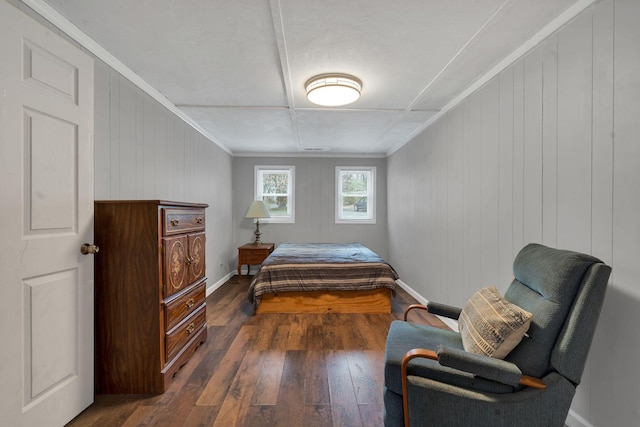 bedroom with dark wood-style flooring, ornamental molding, and baseboards