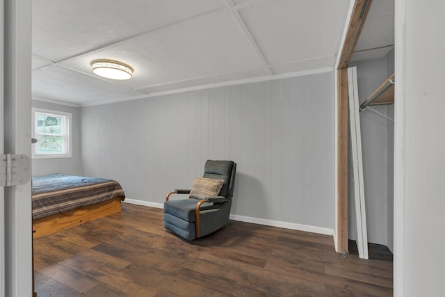 bedroom with baseboards and wood finished floors