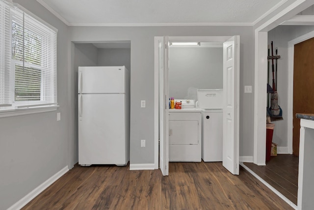 clothes washing area with baseboards, wood finished floors, washing machine and clothes dryer, and ornamental molding