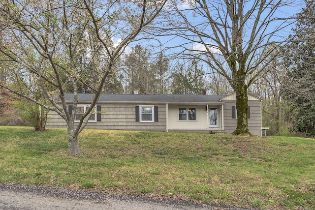 single story home featuring a front lawn and a chimney