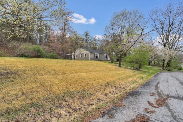 view of front of property with driveway and a front lawn