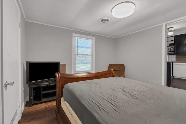 bedroom featuring dark wood-style floors, crown molding, and visible vents