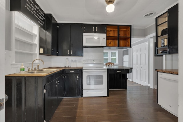 kitchen with open shelves, white appliances, dark wood-style flooring, a sink, and dark cabinets