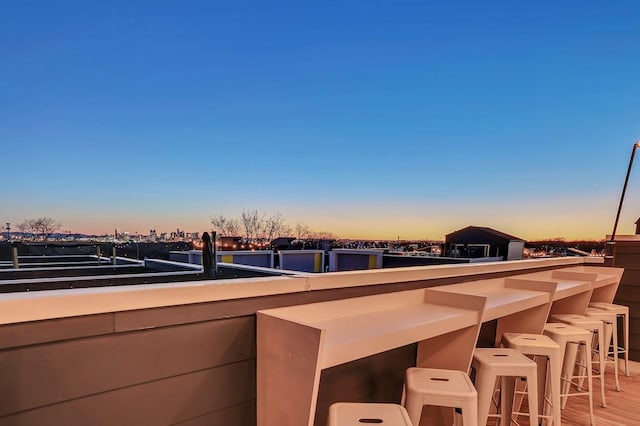 view of patio featuring a balcony and outdoor dry bar