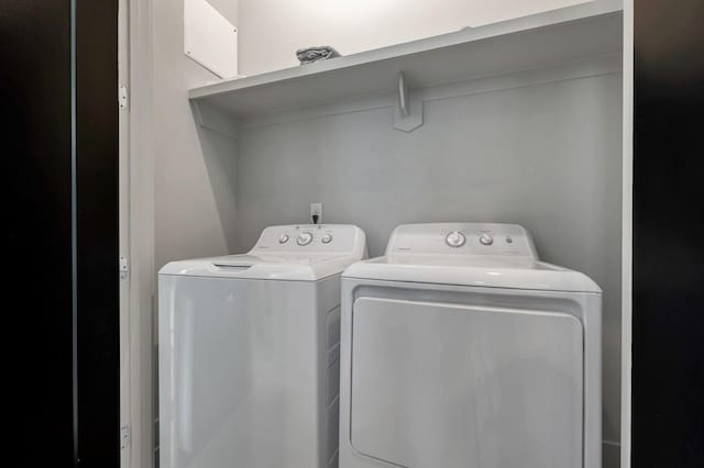 clothes washing area featuring washing machine and dryer and laundry area