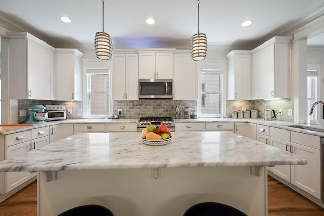 5311 Tennessee Ave Unit A, Nashville, TN 37209 - kitchen featuring a breakfast bar, white cabinetry, a sink, and stainless steel appliances