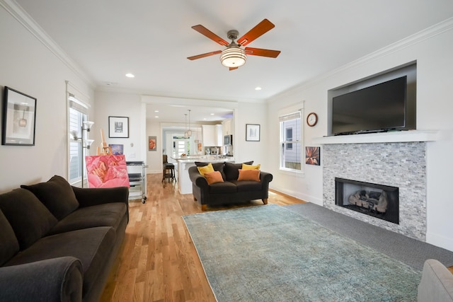 5311 Tennessee Ave Unit A, Nashville, TN 37209 - living room featuring crown molding, baseboards, a ceiling fan, light wood-type flooring, and a glass covered fireplace