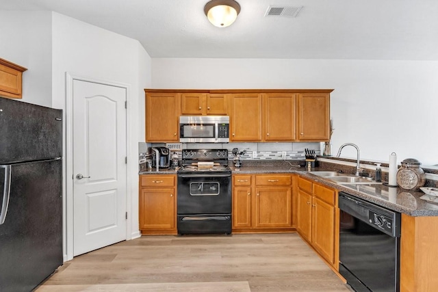 284 Meigs Dr Unit C21, Murfreesboro, TN 37128 - kitchen featuring light wood-style flooring, visible vents, black appliances, a sink, and brown cabinets