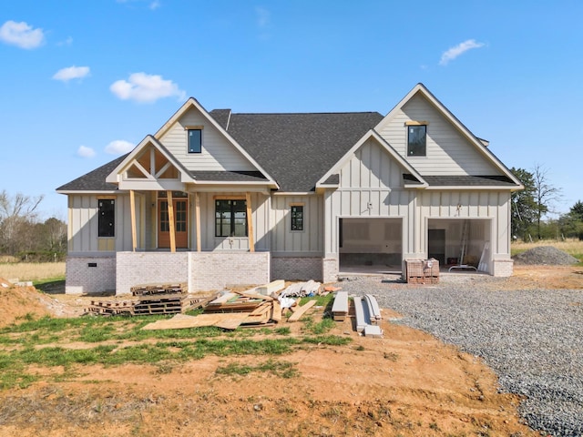 350 Butterfly Cove Trl, Decatur, TN 37322 - view of front of home with a shingled roof, a garage, board and batten siding, brick siding, and driveway