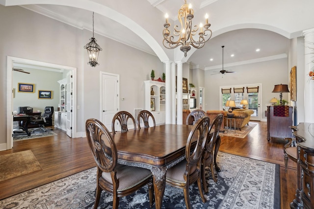 1194 Meadow Bridge Ln, Arrington, TN 37014 - dining area with decorative columns, ornamental molding, ceiling fan with notable chandelier, arched walkways, and wood finished floors
