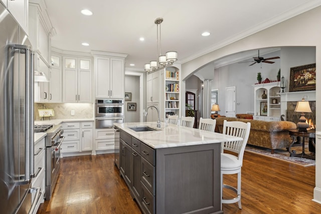 1194 Meadow Bridge Ln, Arrington, TN 37014 - kitchen with decorative columns, a sink, high quality appliances, arched walkways, and ceiling fan