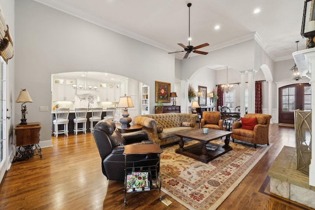 1194 Meadow Bridge Ln, Arrington, TN 37014 - living room with dark wood-style floors, decorative columns, arched walkways, and a towering ceiling