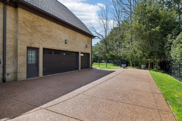 1194 Meadow Bridge Ln, Arrington, TN 37014 - view of property exterior featuring driveway, a shingled roof, a garage, and fence