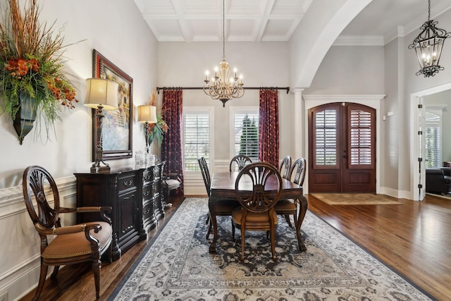1194 Meadow Bridge Ln, Arrington, TN 37014 - dining room featuring coffered ceiling, dark wood-style floors, a notable chandelier, and arched walkways