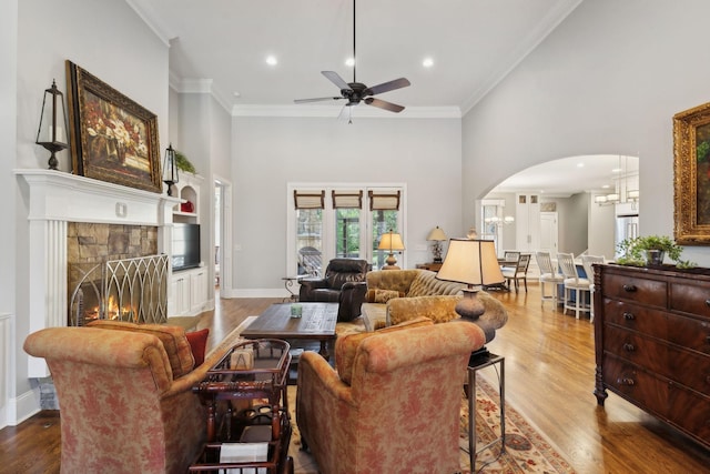 1194 Meadow Bridge Ln, Arrington, TN 37014 - living room featuring crown molding, wood finished floors, a ceiling fan, arched walkways, and a high ceiling