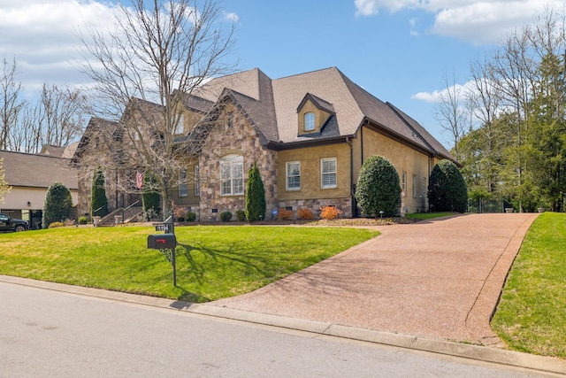1194 Meadow Bridge Ln, Arrington, TN 37014 - view of front facade featuring a front lawn, driveway, stucco siding, and stone siding