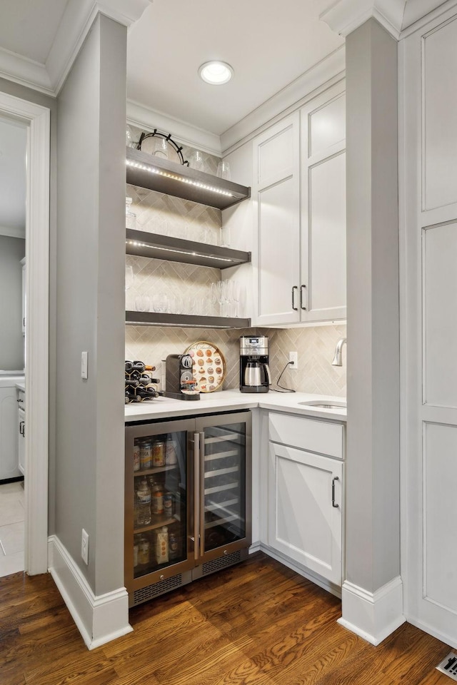 1194 Meadow Bridge Ln, Arrington, TN 37014 - bar featuring backsplash, a sink, beverage cooler, ornamental molding, and dark wood-style flooring