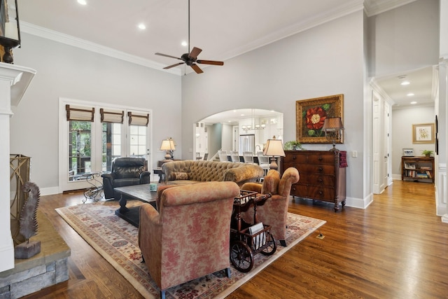 1194 Meadow Bridge Ln, Arrington, TN 37014 - living area with ornamental molding, a high ceiling, arched walkways, a ceiling fan, and wood finished floors