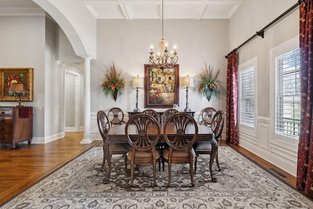 1194 Meadow Bridge Ln, Arrington, TN 37014 - dining area with an inviting chandelier, decorative columns, arched walkways, visible vents, and wood finished floors