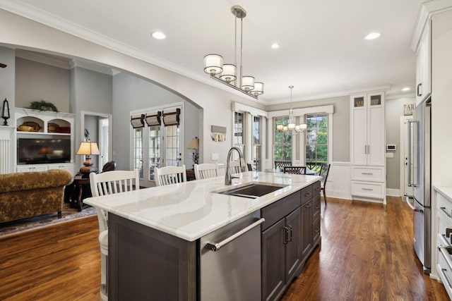 1194 Meadow Bridge Ln, Arrington, TN 37014 - kitchen featuring stainless steel appliances, a chandelier, a sink, arched walkways, and dark brown cabinetry