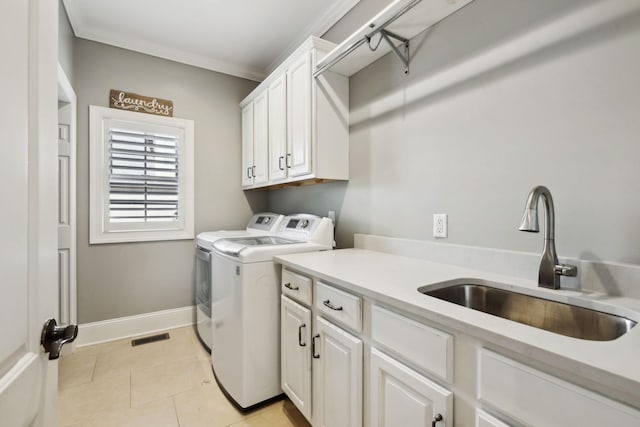 1194 Meadow Bridge Ln, Arrington, TN 37014 - laundry area featuring light tile patterned flooring, baseboards, washing machine and dryer, a sink, and cabinet space