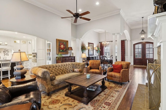 1194 Meadow Bridge Ln, Arrington, TN 37014 - living area featuring crown molding, wood finished floors, decorative columns, arched walkways, and ceiling fan with notable chandelier