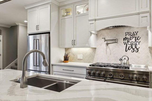 1194 Meadow Bridge Ln, Arrington, TN 37014 - kitchen with premium appliances, decorative backsplash, white cabinets, light stone countertops, and glass insert cabinets