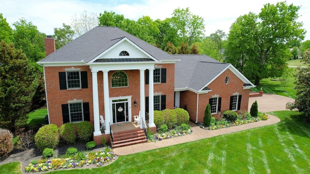 2145 Summer Hill Cir, Franklin, TN 37064 - greek revival inspired property featuring brick siding, a chimney, a front lawn, and a standing seam roof