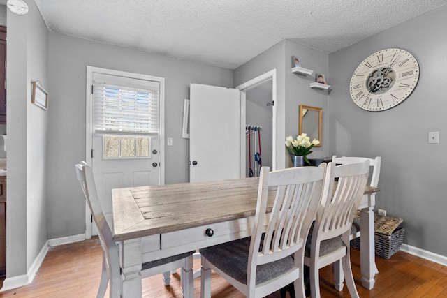 740 Acorn Dr, Clarksville, TN 37043 - dining room featuring baseboards, a textured ceiling, and light wood finished floors