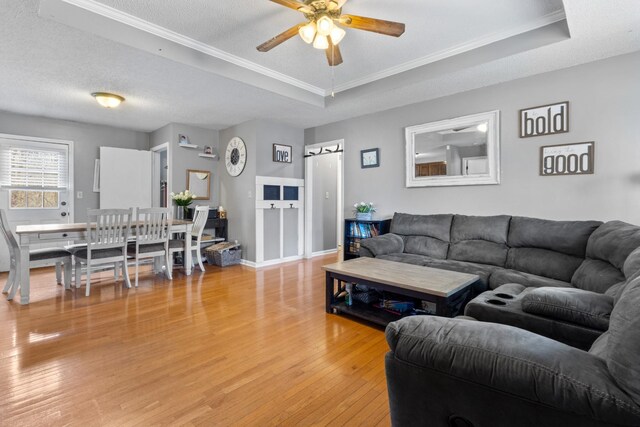 740 Acorn Dr, Clarksville, TN 37043 - living room with a textured ceiling, ceiling fan, light wood-style floors, and a raised ceiling